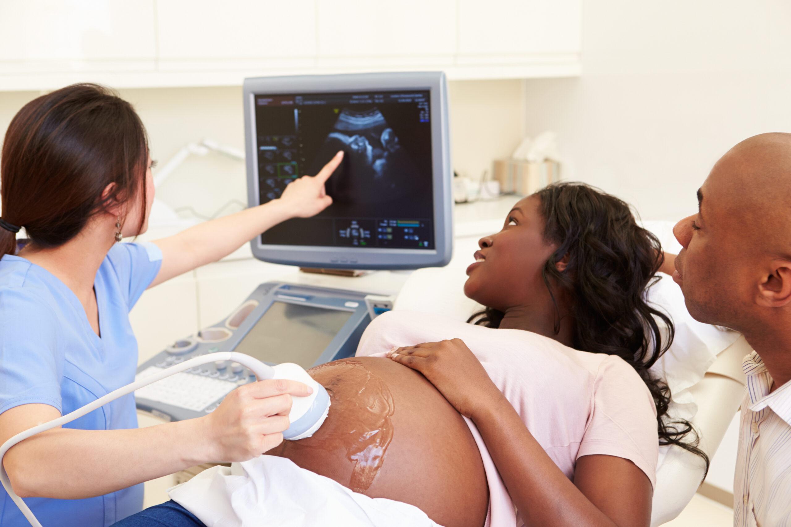 An ultrasound technician on the machine